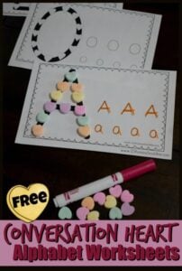 Grab these super cute valentines day worksheets to practice forming letters out of coversation hearts and tracing upper and lowercase letters.  This fun valentines day activities for preschoolers is a super cute way to help toddler, preschool, pre-k, and kindergarten age children practice making their letters.  This free conversation heart printable includes a space to build the letter using conversation hearts and tracing for both upper and lower case letters. Simply print pdf file with valentine's day alphabet worksheets, grab some heart candy, and start practicing!