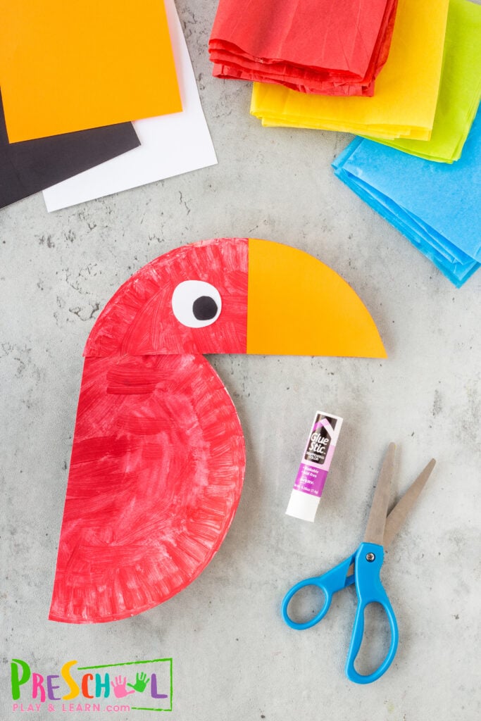 Cut a half circle beak out of orange or yellow construction paper and glue or tape that onto the 1/3 head as well.
