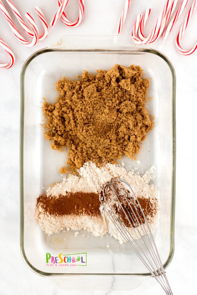 pan or tray with raised edges free gingerbread printable letter tracing cards (at the bottom of the post) candy canes (as pencils) 1-2 cups dark brown sugar ½ cup flour  1-2 Tablespoons cinnamon