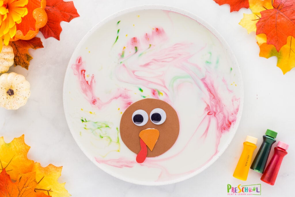 Dip a q-tip in dish soap and gently touch to food coloring. The food coloring will swirl and appear ot jump back in the water making a pretty design for the turkey feathers.