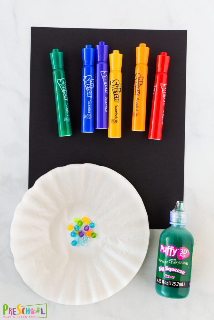 black or green, yellow constructin paper green puffy paint (or use our DIY foam paint recipe) coffee filters Mr Sketch markers (other washable markers work, but these are our favorite!) cup with warm water scissors glue