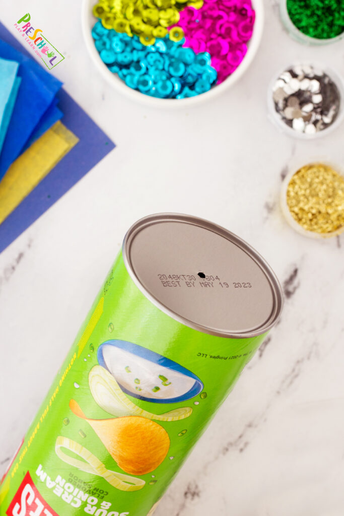 use a hammer and a nail to punch a hole in the center of the bottom of the can