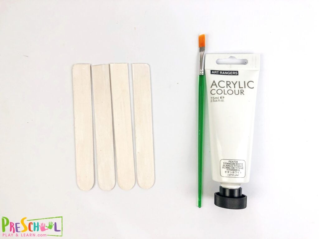 Paint the popsicle sticks white on one side and let it dry.