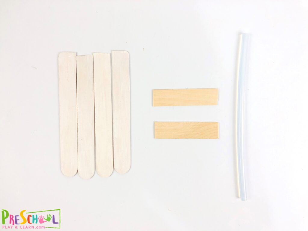 Grab another popsicle stick and cut it into half.